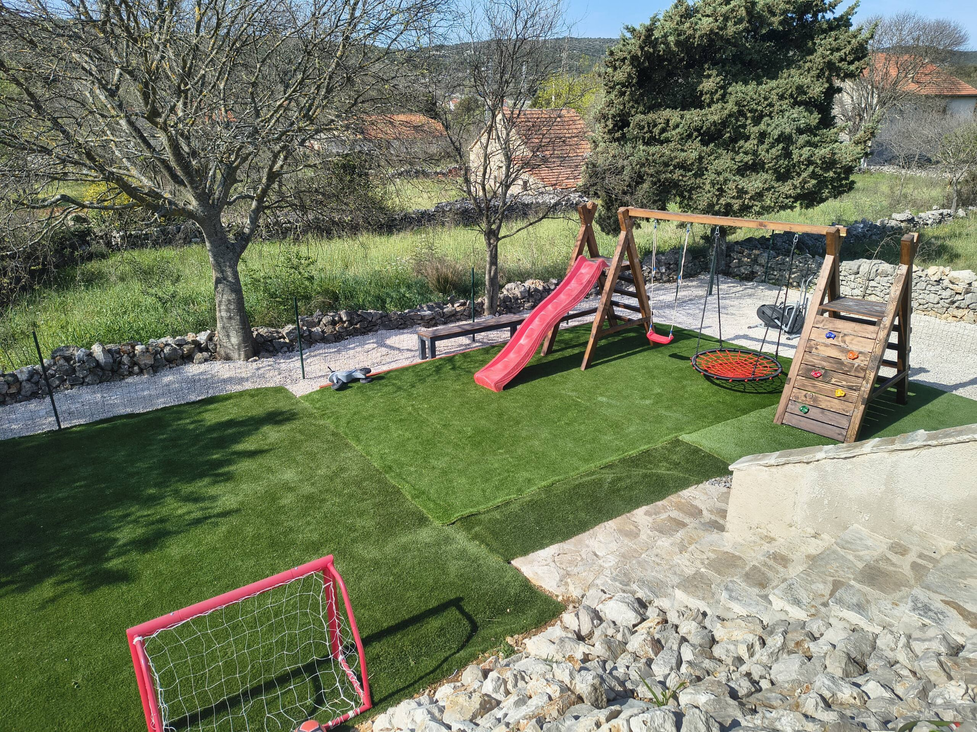 Backyard — lawn, play area & dry-stone walls — Kameni Dvori